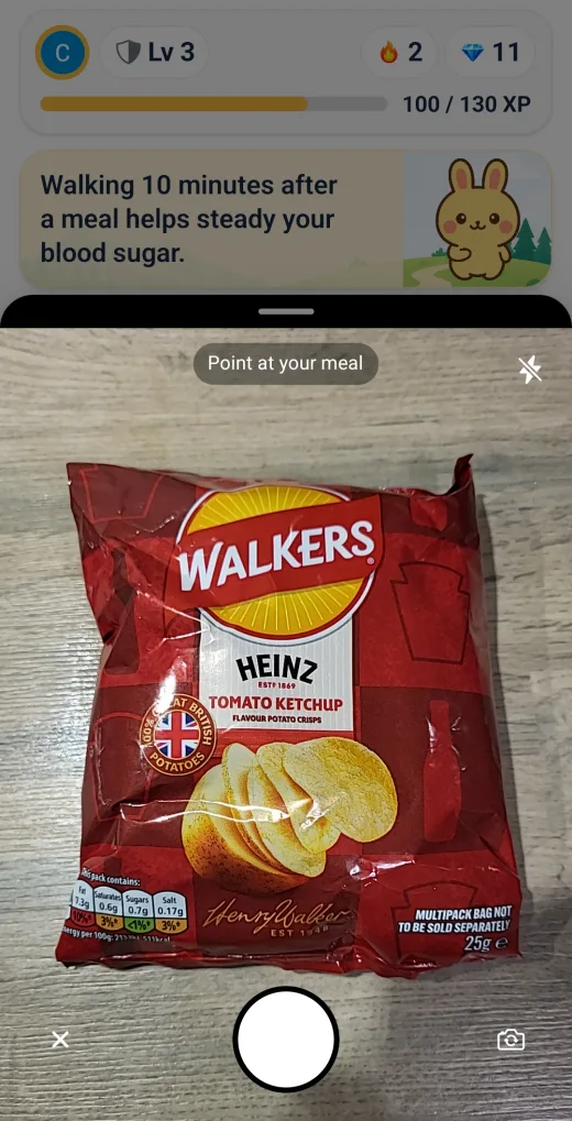CalQuest camera screen framing a packet of crisps for a food scan.
